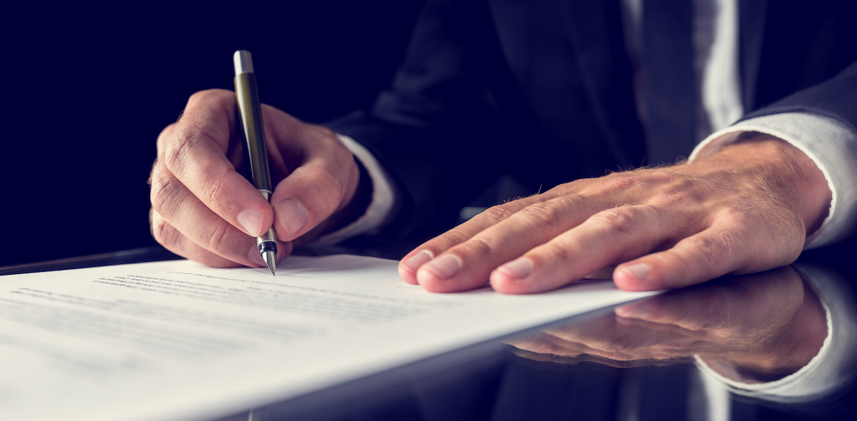 CRI Paid $16M Cash Plus 2.3M Shares For Reflect Acquisition - Retro image of lawyer signing important legal document on black desk. Over black background.