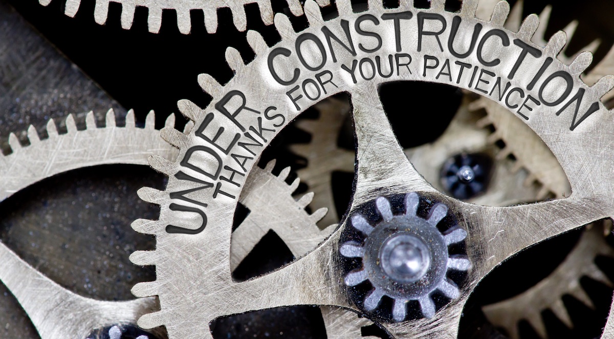 Thanks For Your Patience! - Macro photo of tooth wheel mechanism with UNDER CONSTRUCTION concept words