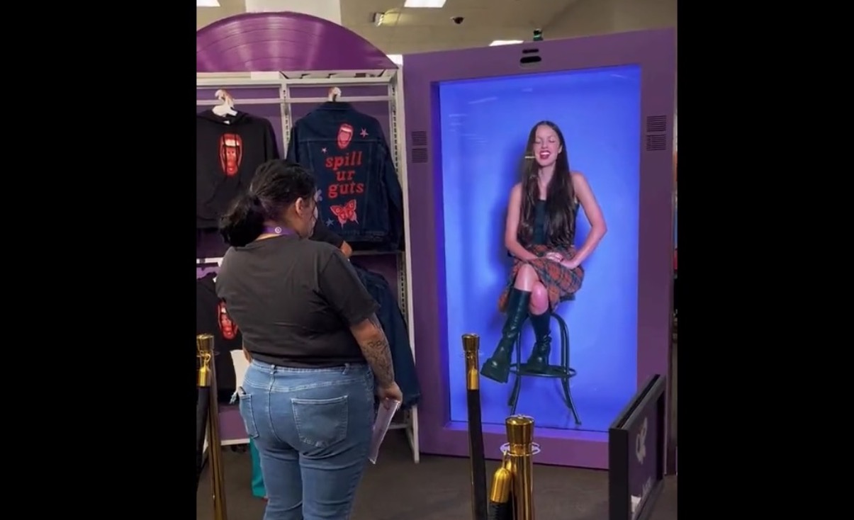 Pop Star Olivia Rodrigo Makes Live Appearance At LA Target Store, But Does So From NYC … Using Transparent LCD Tech