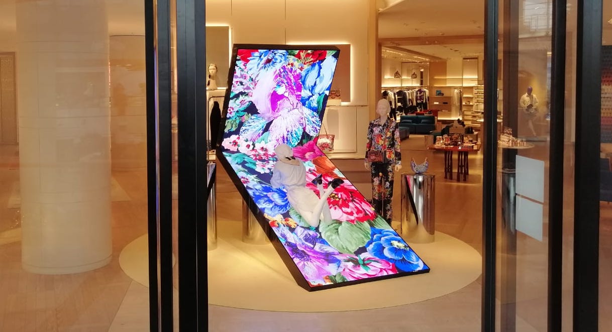 Interesting Digital Fixture Has Mannequin Relaxing Atop Tilted LED Display