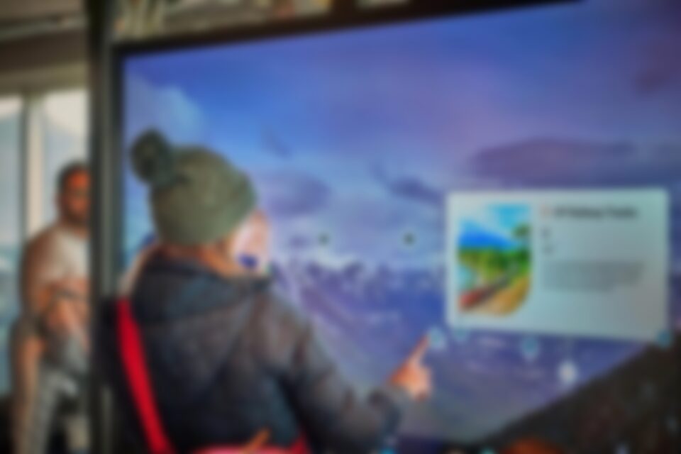 A visitor explores the Banff Gondola’s new Scout Panel, using the interactive touchscreen